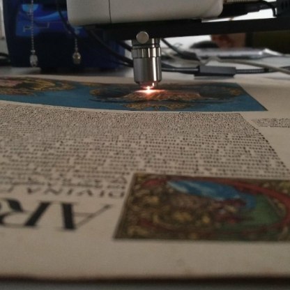 A microscope is trained on part of an illuminated manuscript.